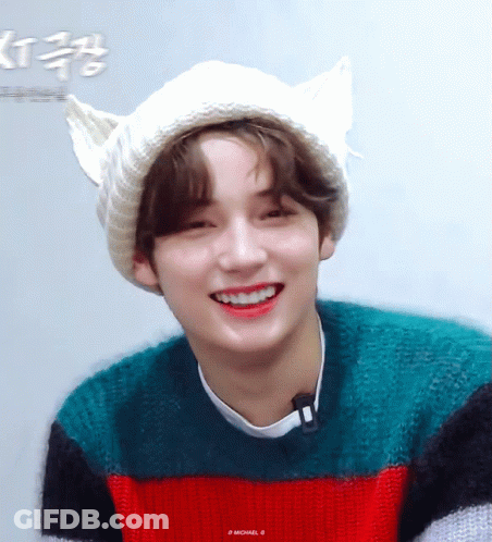 Young Man In Cat Ear Hat And Striped Sweater Smiling GIF