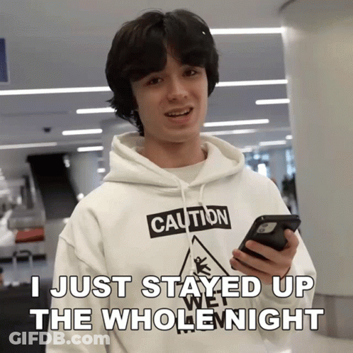 Young Man In Caution Hoodie Holding Phone GIF
