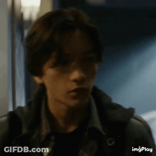 Young Man In Dark Hallway Close Up GIF