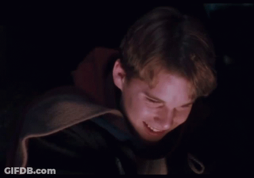 Young Man In Dark Room With Purple Light GIF