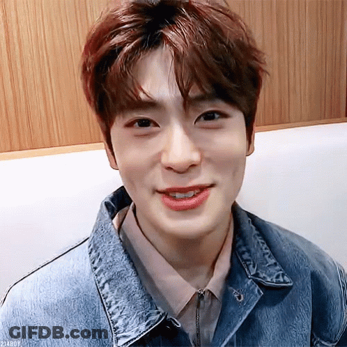 Young Man In Denim Jacket And Pink Shirt Smiling GIF