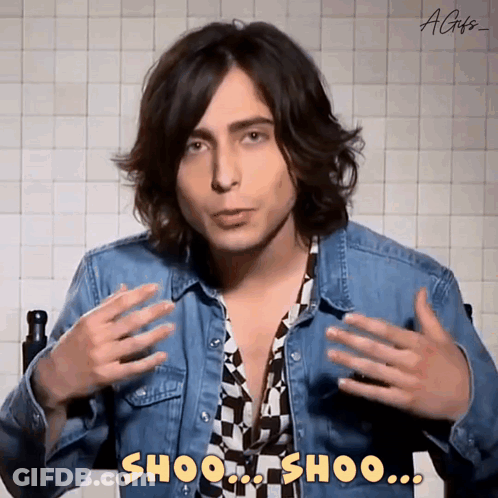 Young Man In Denim Jacket Saying Shoo Shoo GIF