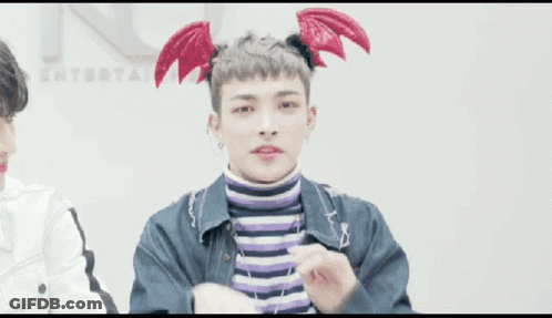Young Man In Devil Wings Headband Making Heart With Hands GIF
