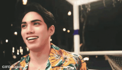 Young Man In Floral Shirt Smiling At Camera GIF