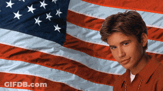 Young Man In Front Of American Flag GIF