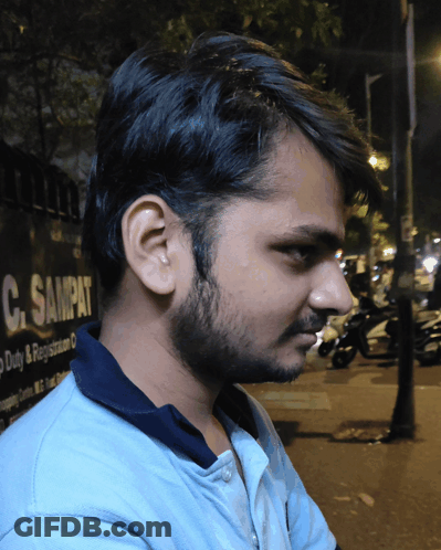 Young Man In Front Of C. Sampat Sign GIF