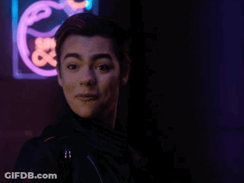 Young Man In Front Of Neon Save Sign GIF