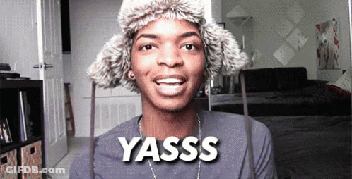 Young Man In Fur Hat And Necklace Saying Yasss GIF
