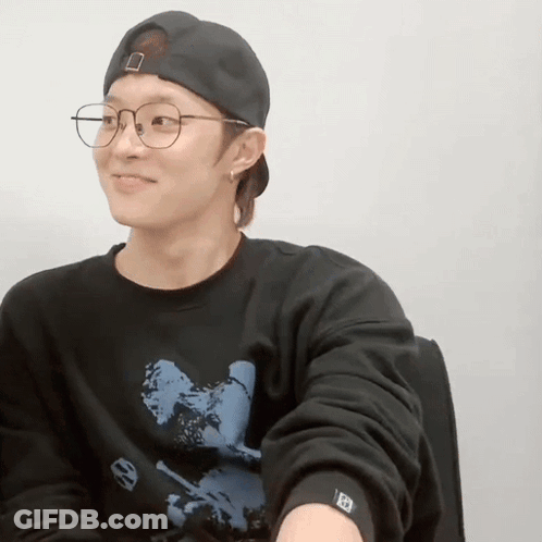 Young Man In Glasses And Baseball Cap Smiling GIF