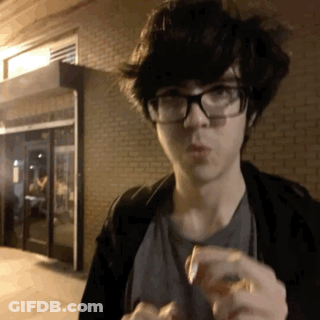 Young Man In Glasses And Black Jacket Eating GIF