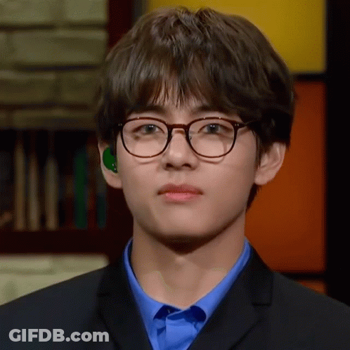 Young Man In Glasses And Blue Shirt Looking At Camera GIF