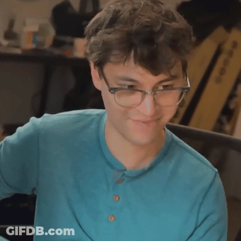 Young Man In Glasses And Blue Shirt Smiling GIF