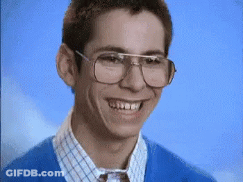 Young Man In Glasses And Blue Sweater Smiling GIF