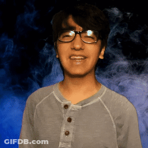 Young Man In Glasses And Grey Shirt Smiling GIF