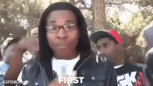 Young Man In Glasses And Hoodie Standing Before Crowd GIF