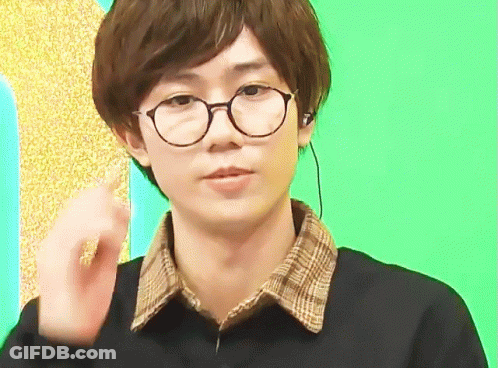 Young Man In Glasses And Plaid Shirt Making Gesture GIF