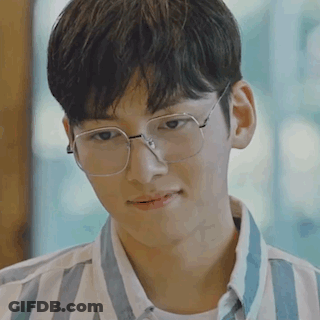 Young Man In Glasses And Striped Shirt Looking At Something GIF
