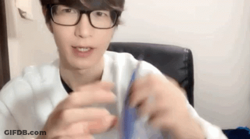 Young Man In Glasses And White Shirt Holding Blue Object GIF