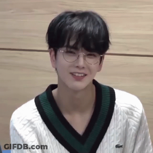 Young Man In Glasses And White Sweater With Green Collar GIF