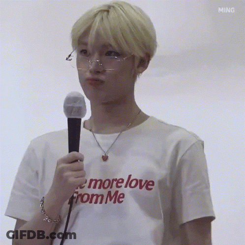 Young Man In Glasses And White T-Shirt Holding Microphone Making Face GIF