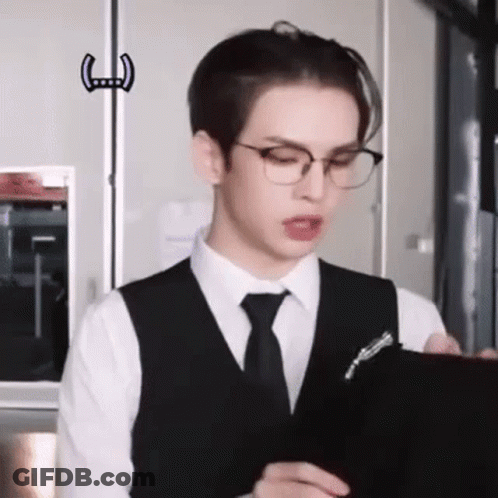 Young Man In Glasses Holding Clipboard GIF
