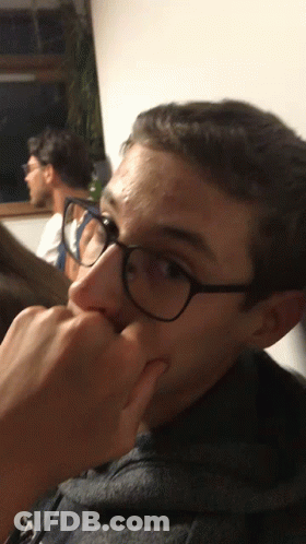 Young Man In Glasses Holding Nose GIF