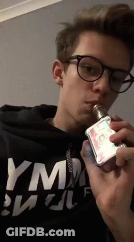 Young Man In Glasses Smoking E-Cigarette With YM Shirt GIF