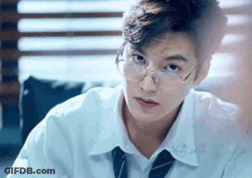 Young Man In Glasses White Shirt And Tie Sitting At Table GIF