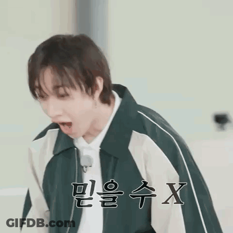 Young Man In Green And White Jacket Making Funny Face GIF