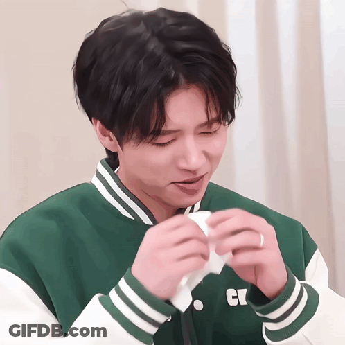 Young Man In Green And White Jacket With Letter C GIF