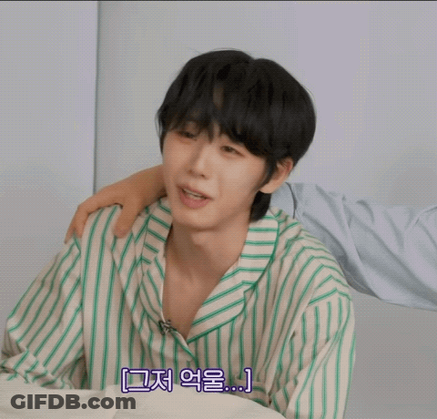Young Man In Green And White Striped Shirt Covering Face GIF