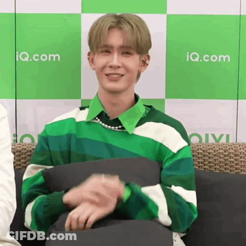 Young Man In Green And White Striped Sweater On Couch GIF