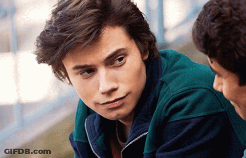 Young Man In Green Jacket Close Up GIF