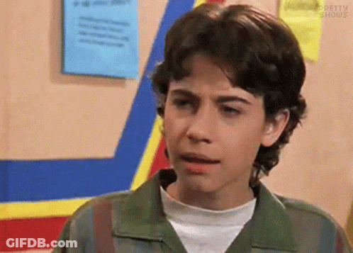 Young Man In Green Jacket With Blue And Yellow Stripe GIF