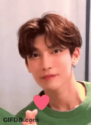 Young Man In Green Shirt Holding Heart GIF