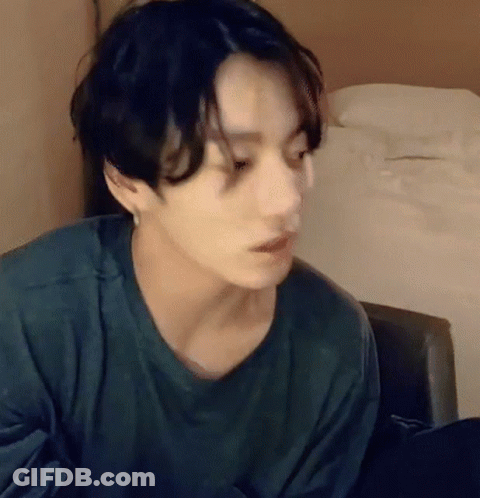 Young Man In Green Shirt Sitting GIF
