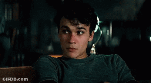Young Man In Green Shirt Sitting On Couch Eyes Closed GIF