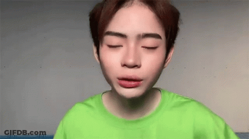Young Man In Green Shirt With Eyes Closed GIF