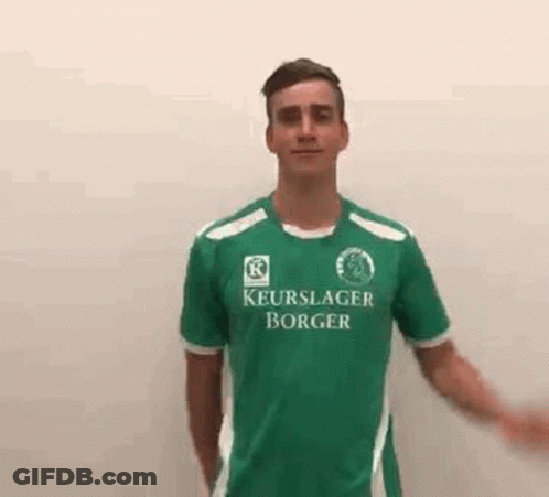 Young Man In Green Soccer Jersey Waving GIF
