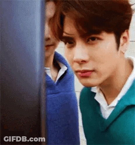 Young Man In Green Sweater Looking At Computer GIF