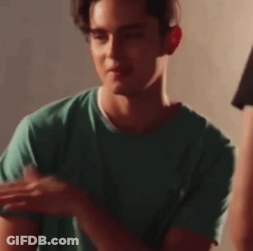 Young Man In Green T-Shirt Holding Fork GIF
