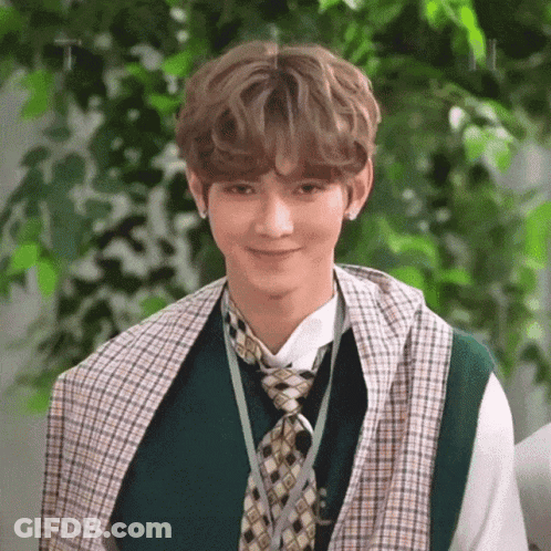 Young Man In Green Vest And Tie Smiling GIF