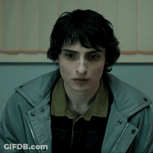 Young Man In Grey Jacket And Black Shirt GIF