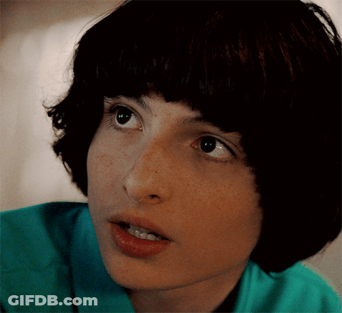 Young Man In Grey Jacket Looking At Watch GIF