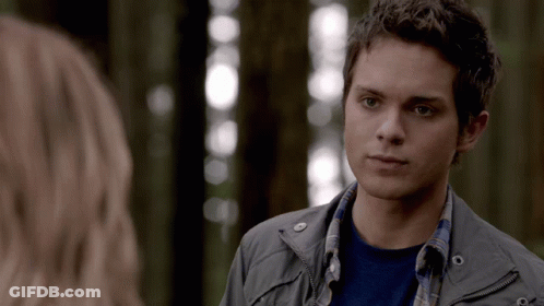 Young Man In Grey Jacket Looks At Woman GIF