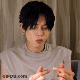 Young Man In Grey Shirt Making Heart With Fingers GIF