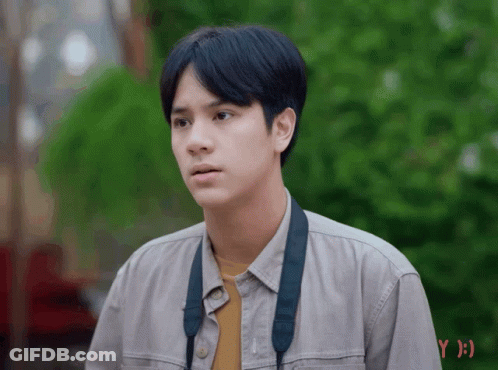 Young Man In Grey Shirt With Black Strap GIF