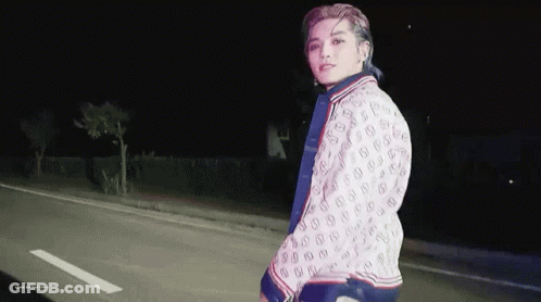Young Man In Gucci Jacket Walking At Night GIF