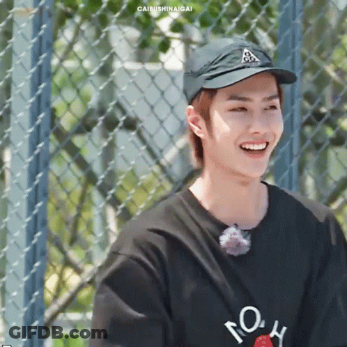 Young Man In Hat And Black Shirt Smiling GIF