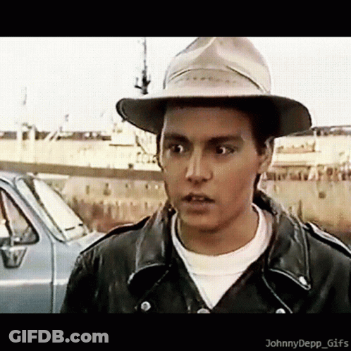 Young Man In Hat And Leather Jacket By Car GIF